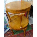 A pair of oak circular occasional tables.