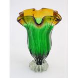 Glass : a mid 20thC Studio glass vase with fluted wavy rim, green body, clear foot and Amber top,
