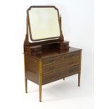 An early 20thC mahogany dressing table, having a bevelled mirror and two short drawers above,