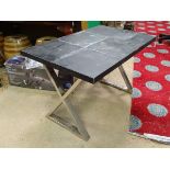 A leather covered occasion table with X-frame chrome trestles CONDITION: Please