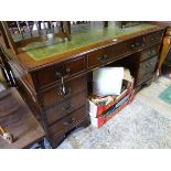A late 20thC green leather inlaid pedestal/partners desk,