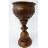 A turned wooden jardiniere stand CONDITION: Please Note - we do not make reference