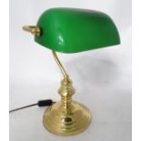 A brass desk lamp with a green glass shade CONDITION: Please Note - we do not make