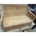 A wicker settee CONDITION: Please Note - we do not make reference to the condition