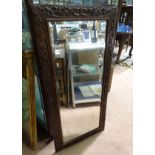 A mirror with a carved oak frame CONDITION: Please Note - we do not make reference