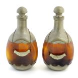 A pair of dimple like brown glass and pewter mounted decanters with bottle tags marked 'Cognac' &