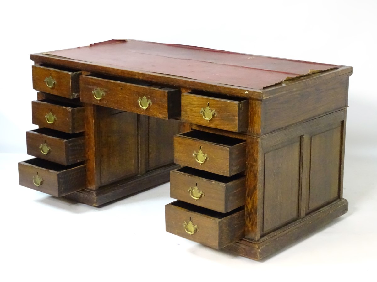 An early 20thC oak pedestal desk comprising a single long central drawer flanked by four short - Image 2 of 7