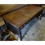 A wrought iron coffee table with a mahogany top CONDITION: Please Note - we do not