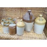 A collection of flagons and storage jars of various sizes, makers to include F. Mitchell & Co.