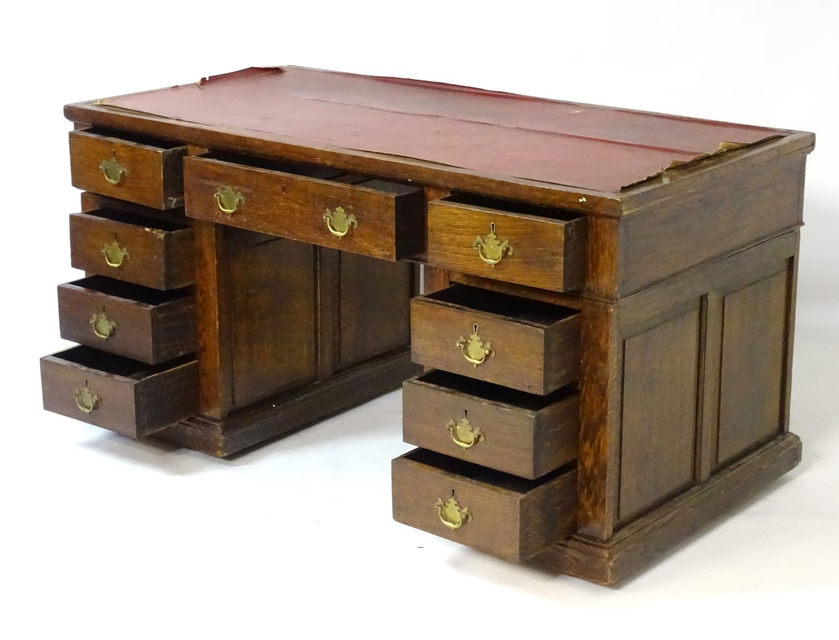An early 20thC oak pedestal desk comprising a single long central drawer flanked by four short - Image 3 of 7