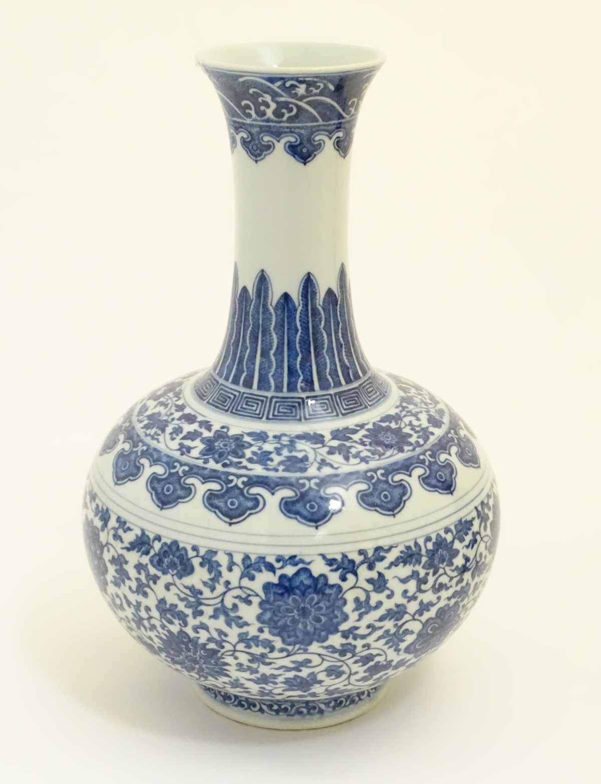 A Chinese blue and white 'Shang Ping' vase decorated with a broad band of flowers and scrolling