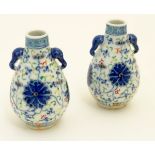 A pair of Chinese miniature doucai baluster vases, decorated with flowers,