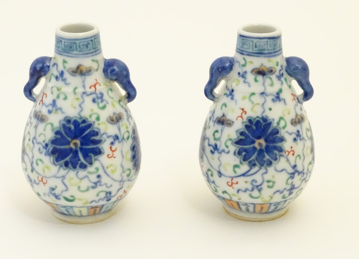 A pair of Chinese miniature doucai baluster vases, decorated with flowers, - Image 3 of 6