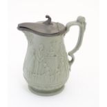 A stoneware pitcher with hinged lid by E.