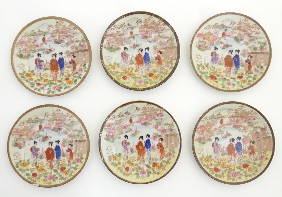 Six Japanese plates depicting figures in traditional dress in an Oriental landscape depicting Mount