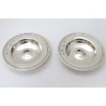 A pair of silver pin dishes formed as miniature Armada dishes.