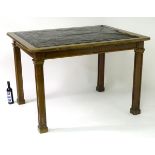 An early 20thC mahogany writing / architects table with an inset top and surrounding wooden frame,