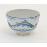 A Laurence McGowan British studio pottery footed bowl, with blue hand painted fish decoration.