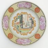 A Chinese plate with a central panel depicting an interior scene with figures and a garden,