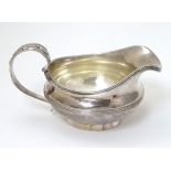 A silver jug hallmarked London 1826 maker William Bateman.