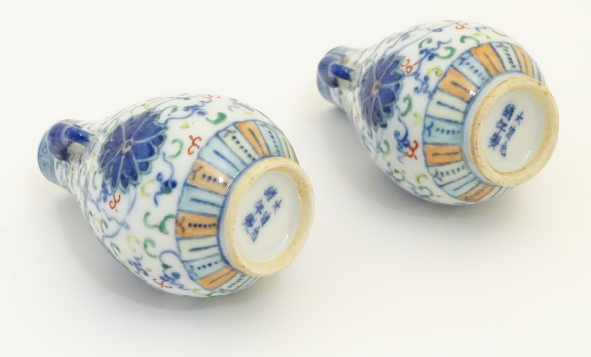 A pair of Chinese miniature doucai baluster vases, decorated with flowers, - Image 6 of 6