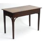 A mid / late 18thC mahogany table with a rectangular top above two end drawers and standing on