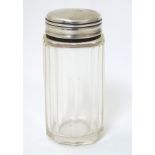 A glass jar with silver top 3 1/4" high CONDITION: Please Note - we do not make