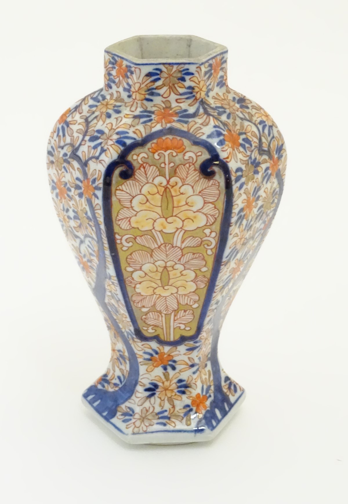An Imari style hexagonal vase with panelled floral decoration and gilt highlights. 7 1/2" high.