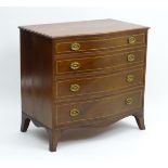 A George III mahogany serpentine fronted chest of drawers comprising four long graduated drawers,