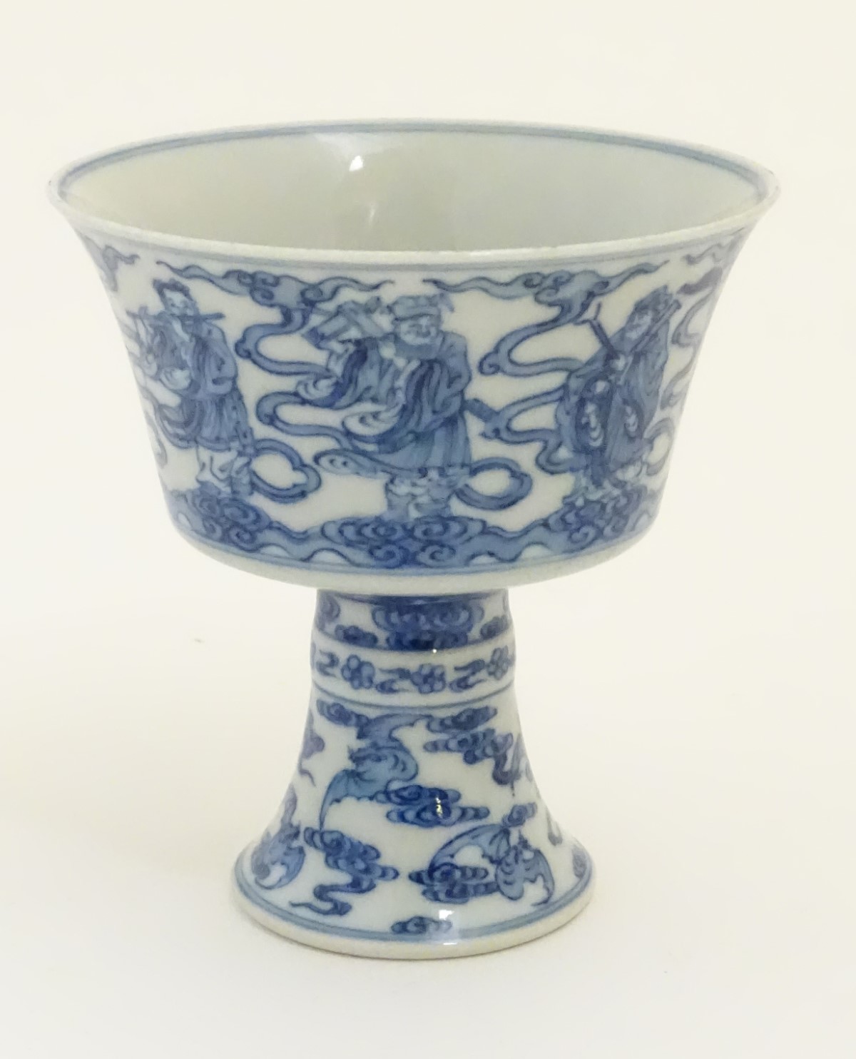 A Chinese blue and white stem cup / high footed cup decorated with stylised clouds,