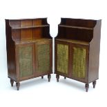 A pair of mahogany Regency bookcases with waterfall shaped shelves above grilled doors and standing