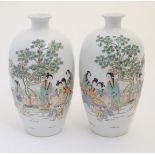 A pair of 20thC Chinese vases decorated with figures on a terrace in a landscape. Approx.