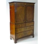 A late 18thC / early 19thC mahogany linen press with a moulded cornice above a marquetry inlaid