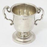 A miniature silver two handled trophy cup hallmarked Birmingham 1929 2" high (24g)