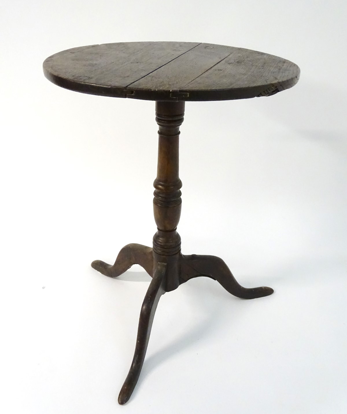 A late 18thC oak tripod table with a circular table top above a turned stem and standing on three - Image 7 of 7