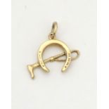 A 9ct gold pendant / charm formed as a horseshoe with a riding crop / whip 3/4" long