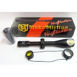 A boxed Nikko-Stirling 'Nighteater' 12x50 telescopic sight, with manual, sun shade, lens cover,