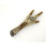 A kilt pin / brooch formed as a grouse foot with with white metal mount.