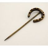 A gilt metal stick pin surmounted by a horseshoe 2 3/4" long CONDITION: Please