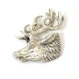 A silver ( white metal) brooch formed as a stags head.