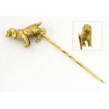 A 9ct gold stick pin surmounted by image of a Spaniel type dog.