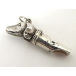A vintage silver novelty whistle with dog head decoration. Hallmarked London 1977.