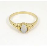 A 14k gold ring set with opal cabochon.