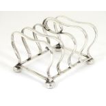 A silver 5-bar toast rack hallmarked Birmingham 1935 maker Charles S Green & Co Ltd.