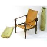 A pair of vintage campaign / safari chairs with original kit bags,