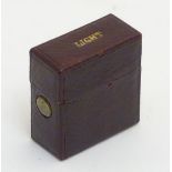 A leather cased travelling stationary vesta, for lighting wax seals,
