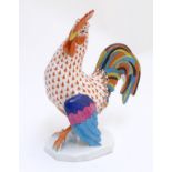 A hand painted Herend porcelain model of a colourful cockrell with gilt highlights. Approx. 9" high.