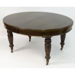 A late 19thC / early 20thC walnut 'Shoolbred' dining table bearing a bone plaque 'James Shoolbred &