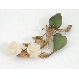 A brooch formed as a floral branch with green jade leaves and white jade flower / rose heads.