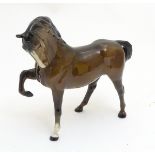 A Beswick horse with a leg raised and head tucked, model no. 1549. Marked under. Approx.